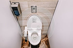 Top View Of Modern Toilet Bowl, And Toilet Paper In The white room is public restroom
