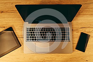 Top view of modern wireless electronic devices on office table