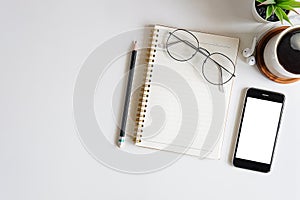 Top view of modern workplace with keyboard, headphones, notebook, office supplies and copy space