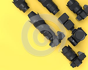 Top view of monochrome designer workspace and photography gear on yellow