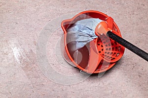 top view of mop in red bucket with dirty water