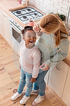 Top view of mother and daughter trying their homemade cookies