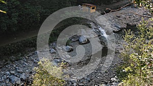 Top view. Mountain river in the Alps. A small guardhouse, ranger's hut.