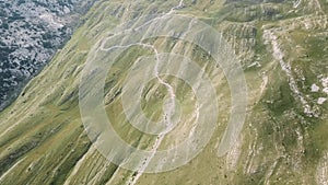 Top view of mountain road. Stock. Dangerous winding roads on mountain slopes. View of road in mountains breathtaking