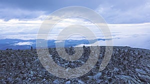 Top view of the mountains with Pyramid of rocks on top. Clip. Stone tower in the top of a mountain