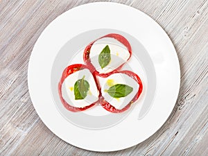 Top view of mozzarella, tomato, basil in stacks