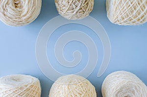 Top view of multi-colored woolen balls of yarn in a row