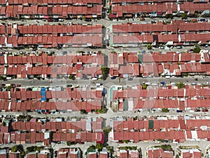 Top view of multiple blocks of townhouses with red steel roofs. A crowded subdivision in Imus, Cavite, Philippines