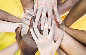 Top view of multiracial stacking hands - International friendship