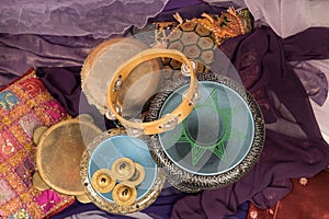 Top view of musical instruments of a bellydance percussiongroup with darbuka`s, tambourines and zills