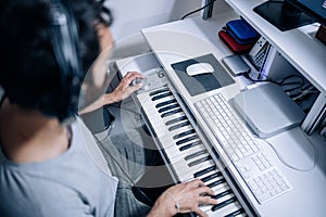 Top view of musician Playing Electric Piano at home recording studio