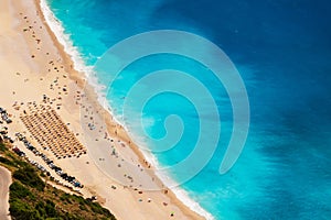 Top view at Myrtos Beach with turquoise and blue Ionian Sea water. Summer scenery of famous and extremely popular travel