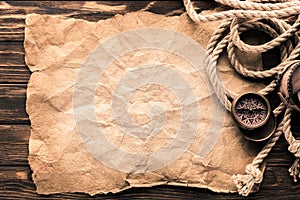 top view of navigation compass and rope on blank