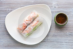 Top view of Nem cuon rolls on plate on table