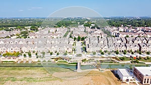 Top view new development riverside residential and commercial neighborhood with vacant land in Texas, USA