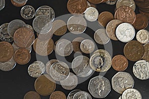 Top view New one pound sterling coin and penny on black background, Pile of different British money coins for business exchange,