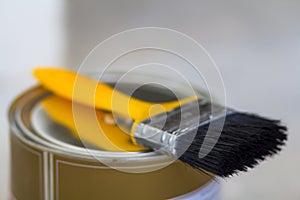 Top view of new shiny clean sealed tin full of red paint and painting brush on it, isolated on white. Tools, materials, building