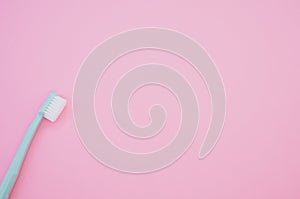 Top view of a new toothbrush isolated on a pink background