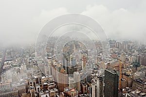 Top view of New York skyline in rainy and cloudy day. Skyscrapers of NYC in the fog
