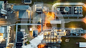 Top view at night on an oil and gas tank with a top view on the background of an oil refinery at night, Business petrochemical