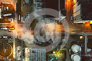Top view at night on an oil and gas tank with a top view on the background of an oil refinery at night, Business petrochemical