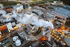 Top view at night on an oil and gas tank with a top view on the background of an oil refinery at night, Business petrochemical