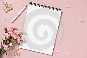 Top view note book anf flowers on the desktop. For wedding planner concept