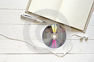 top view of notebook dvd disc and earphone