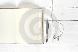 Top view of notebook and earphone