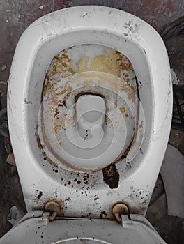 top view oÐ° crap Restroom in abandoned building. unwashed toilet white bowl ceramic full of urine. Old dirty toilet. water
