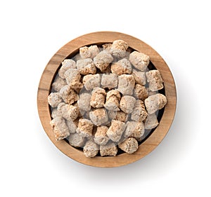 Top view of oats bran pellets in wooden bowl