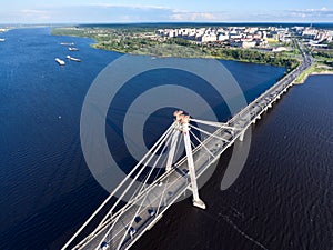 Top view of the Octyabrsky Suspension Bridge across the Sheksna river with traffic on highway. Cherepovets, Vologda region, Russia