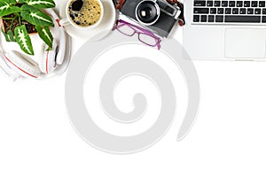 Top view of office desk table with coffee cup, laptop and retro camera isolated