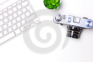 Top view of office graphic design pen mouse with laptop wireless mouse and vintage old camera on white table. Concept