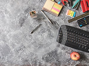 Top view of Office supplies on Grunge gray background.