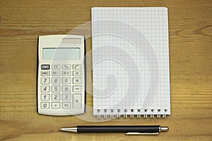 Top view office table calculator with pen on the table for business and copy space.