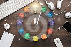 Top view of an office table with great idea concept. problem solution concept depicted by colorful crumpled paper and light bulb