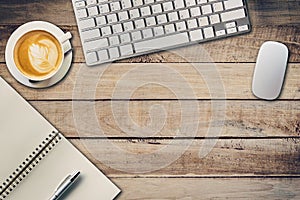 Top view office table with notepad, computer and coffee cup