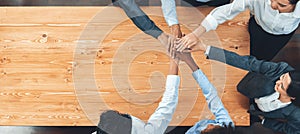 Top view office worker's hand stack shows solidarity in workplace. Concord