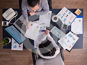 Top view of office workers meeting analyzing financial charts