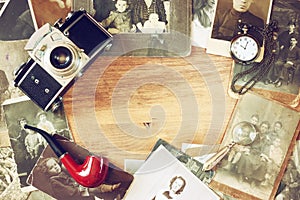 Top view of old camera, antique photographs and old pocket clock