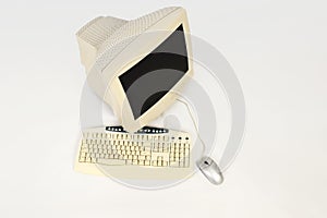 Top view of an old computer screen, keyboard and mouse.