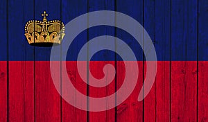 Top view of Old Painted Flag of Liechtenstein on Dark Wooden Fence, wall. patriot and travel concept. no flagpole. Flag background