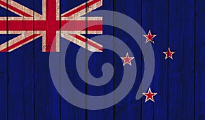Top view of Old Painted Flag of New Zealand on Dark Wooden Fence, wall. patriot and travel concept. no flagpole. Flag background.