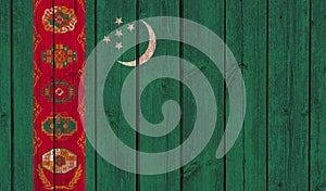 Top view of Old Painted Flag of Turkmenistan on Dark Wooden Fence, wall. patriot and travel concept. no flagpole. Flag background