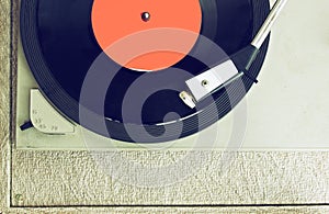 Top view of old record player, image is retro filtered photo