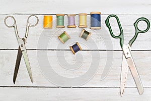 Top view on old scissors, cottons on wooden desk