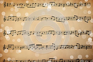 Top view of old sheet with Christmas music notes as background, bokeh effect