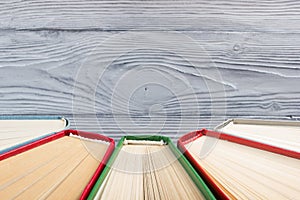 Top view of old used colorful hardback books. Back to school.