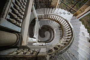 Top view of old vintage decorated spiral staircase in abandoned mansion